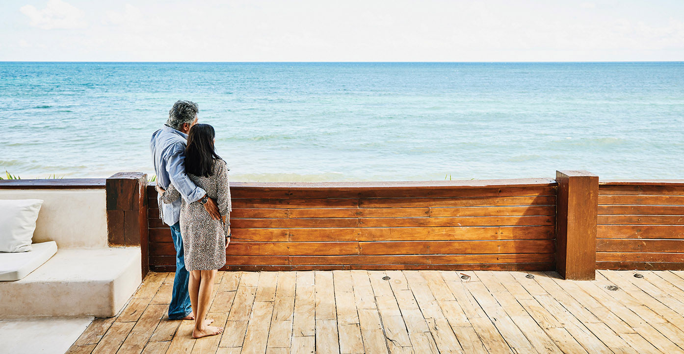 Couple on deck looking at ocean.