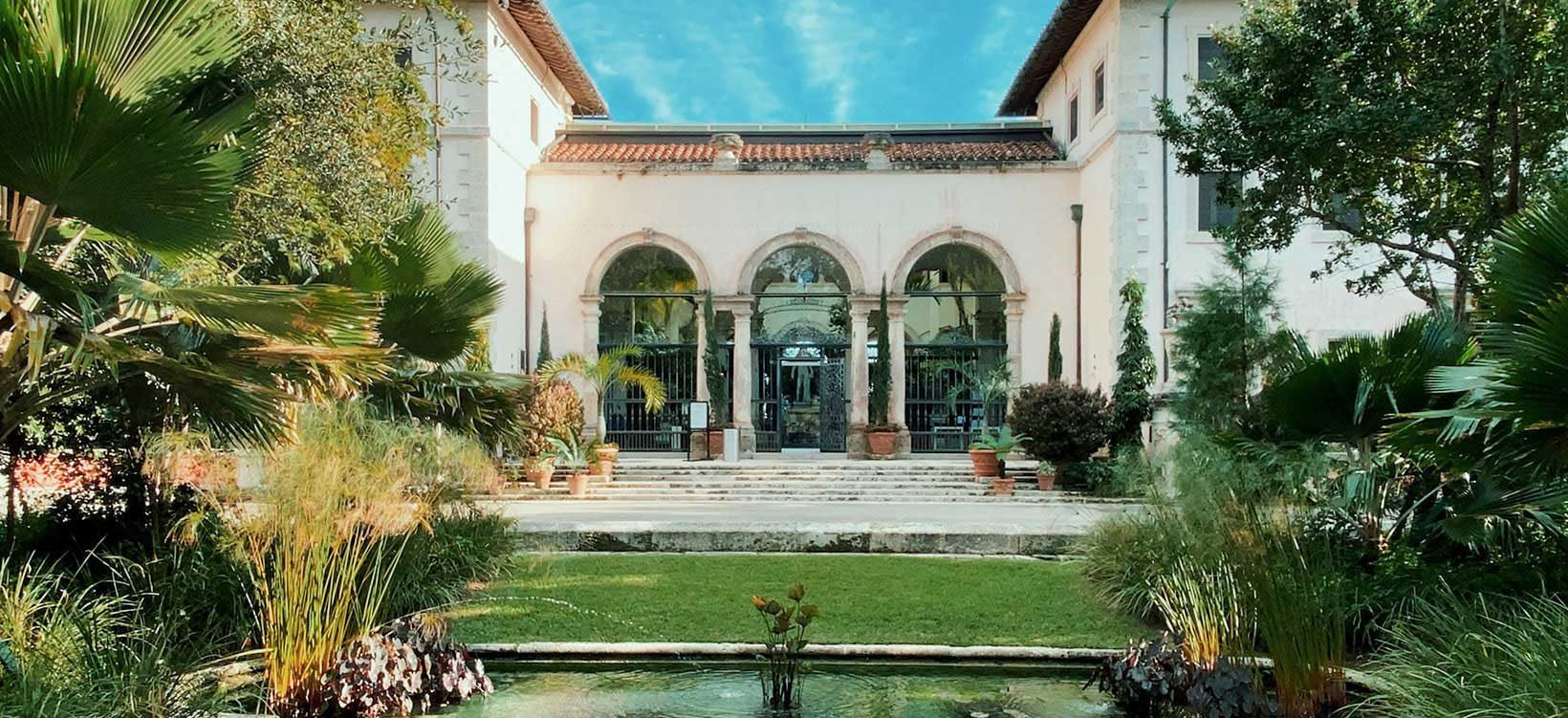 View of garden in backyard of mansion.