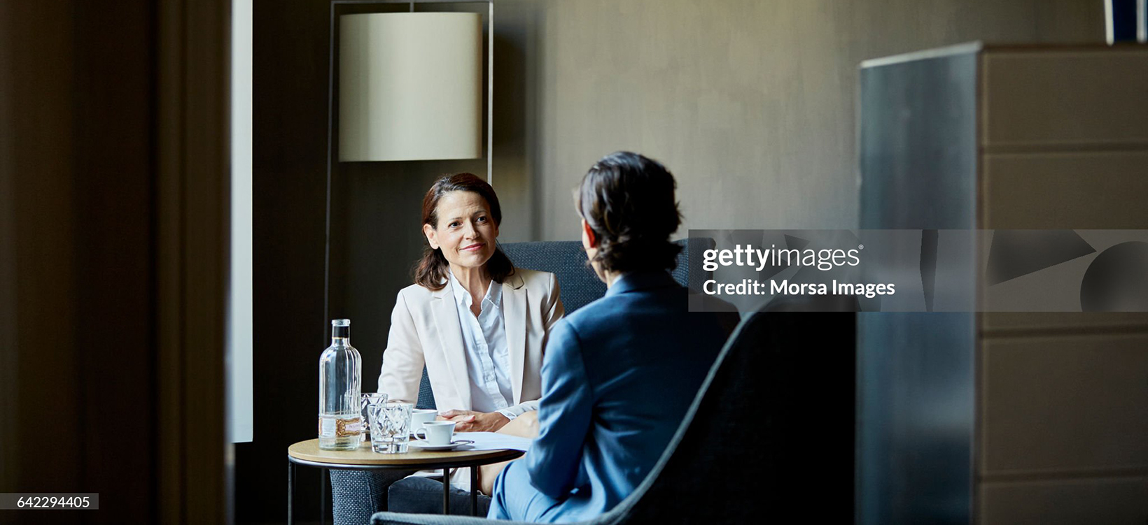 Smiling businesswoman in meeting at hotel room 